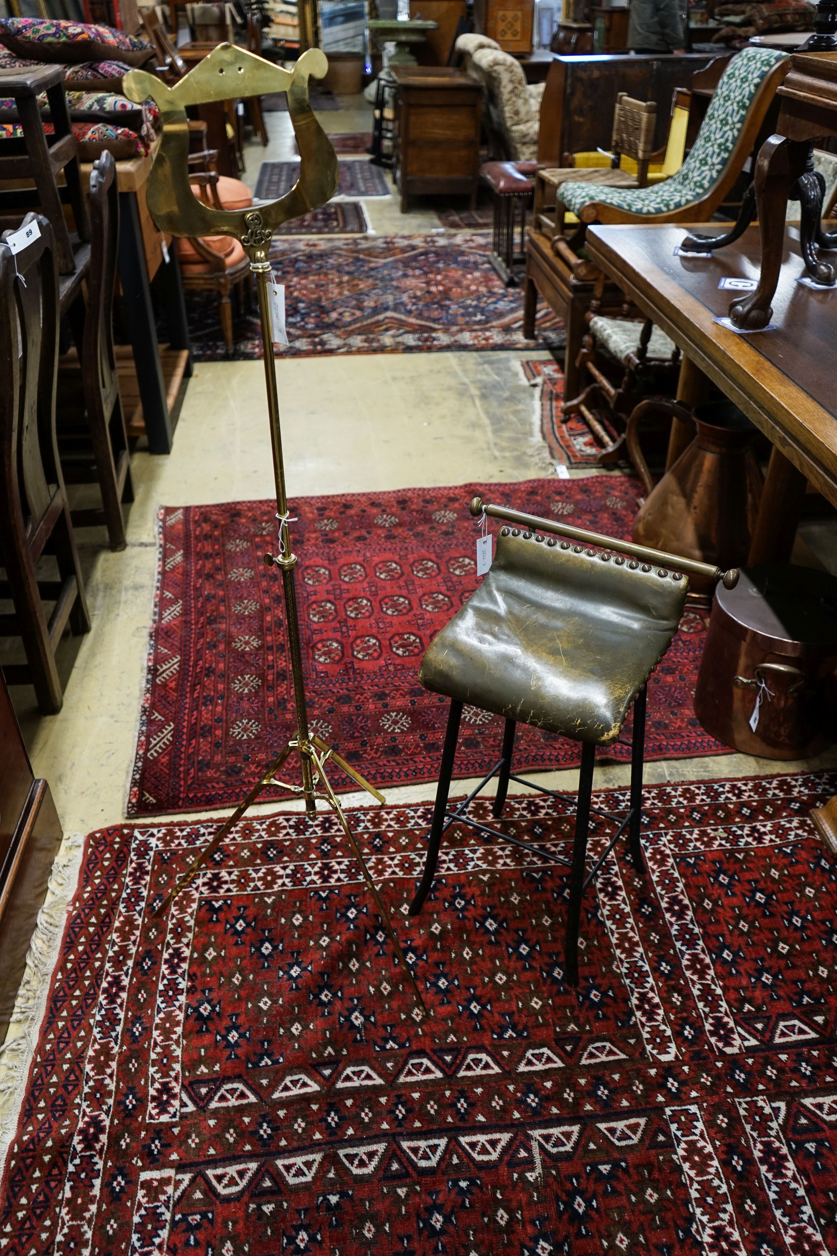 An Edwardian brass music stand and stool